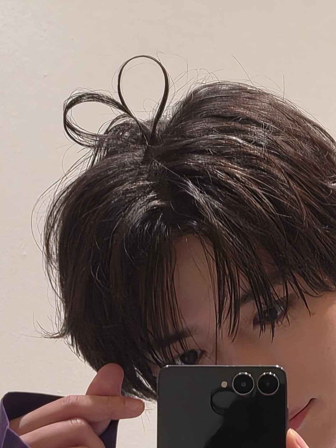 Photo by BEOMGYU of TXT on February 09, 2026. May be an image of one or more people, hair, phone and mirror.