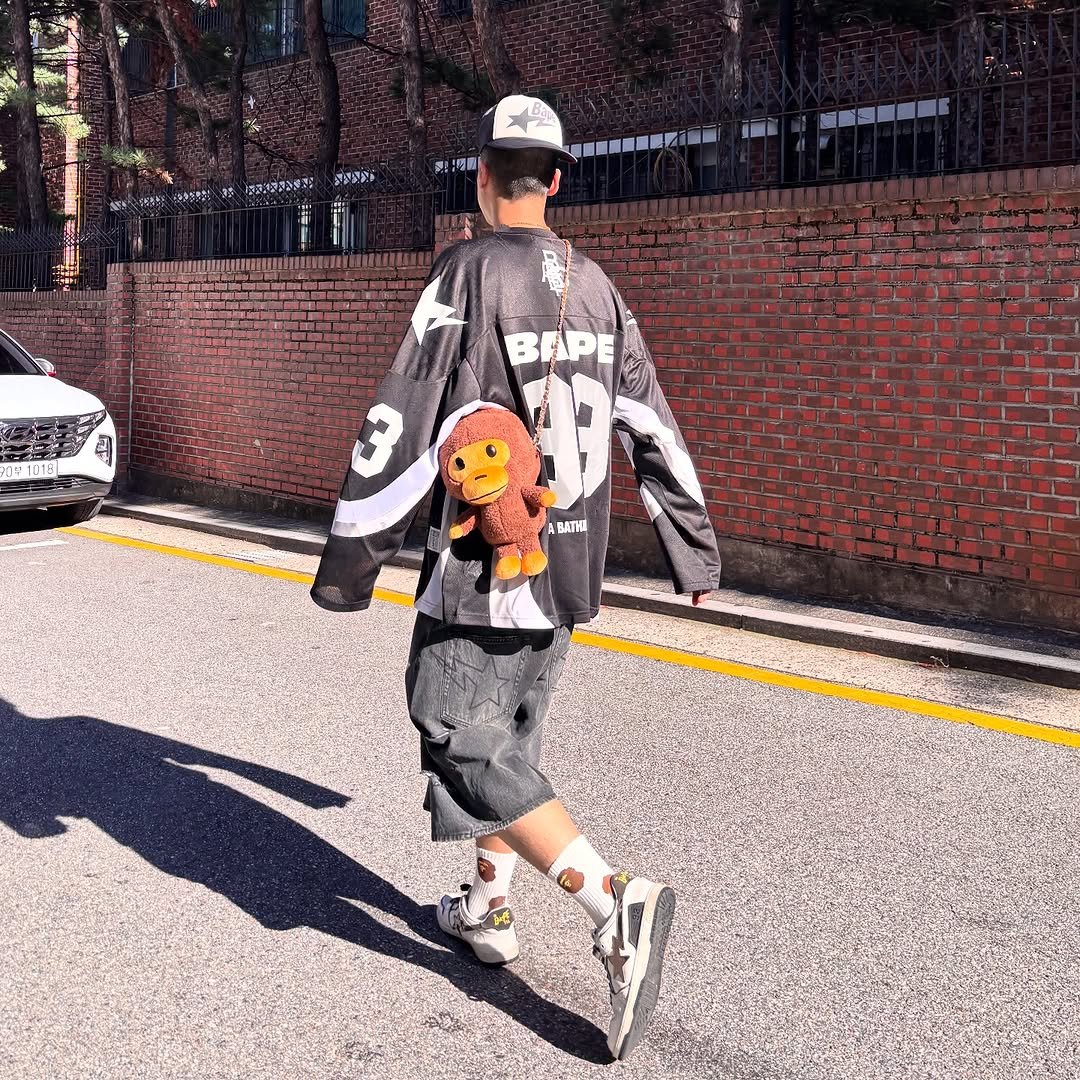 Photo shared by BAPE SEOUL on October 12, 2025 tagging @bapestorekorea, and @bape_seoul. May be an image of skateboard, segway, sportswear, street and text.