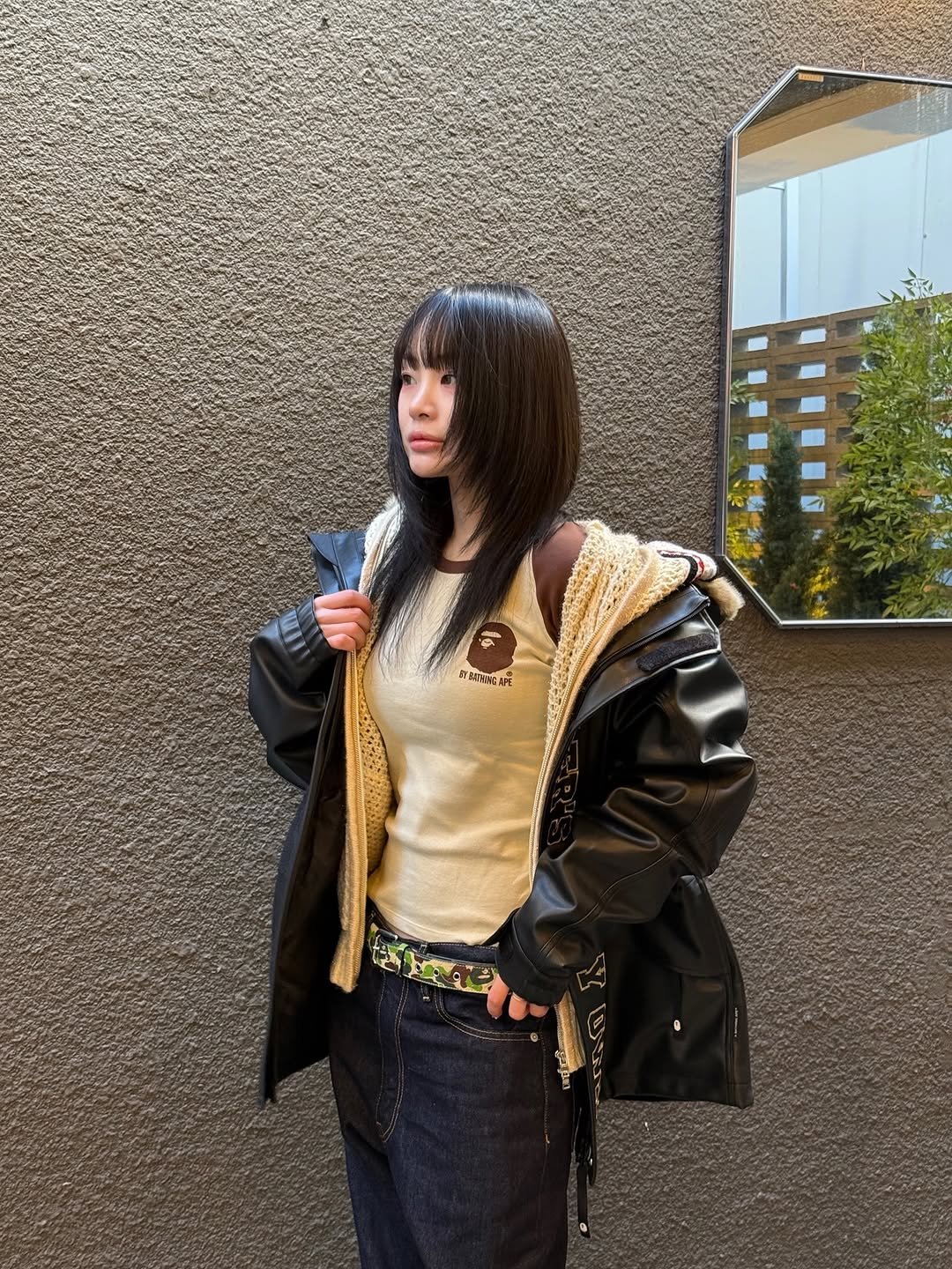 Photo shared by BAPE SEOUL on January 23, 2026 tagging @bapestorekorea, and @bape_seoul. May be an image of duffle coat, overcoat, bolo tie, jacket, turtleneck, parka and text.