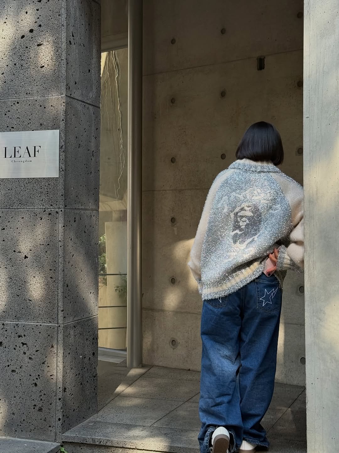 Photo shared by BAPE SEOUL on October 22, 2025 tagging @bapestorekorea, and @bape_seoul. May be an image of standing, street and text.