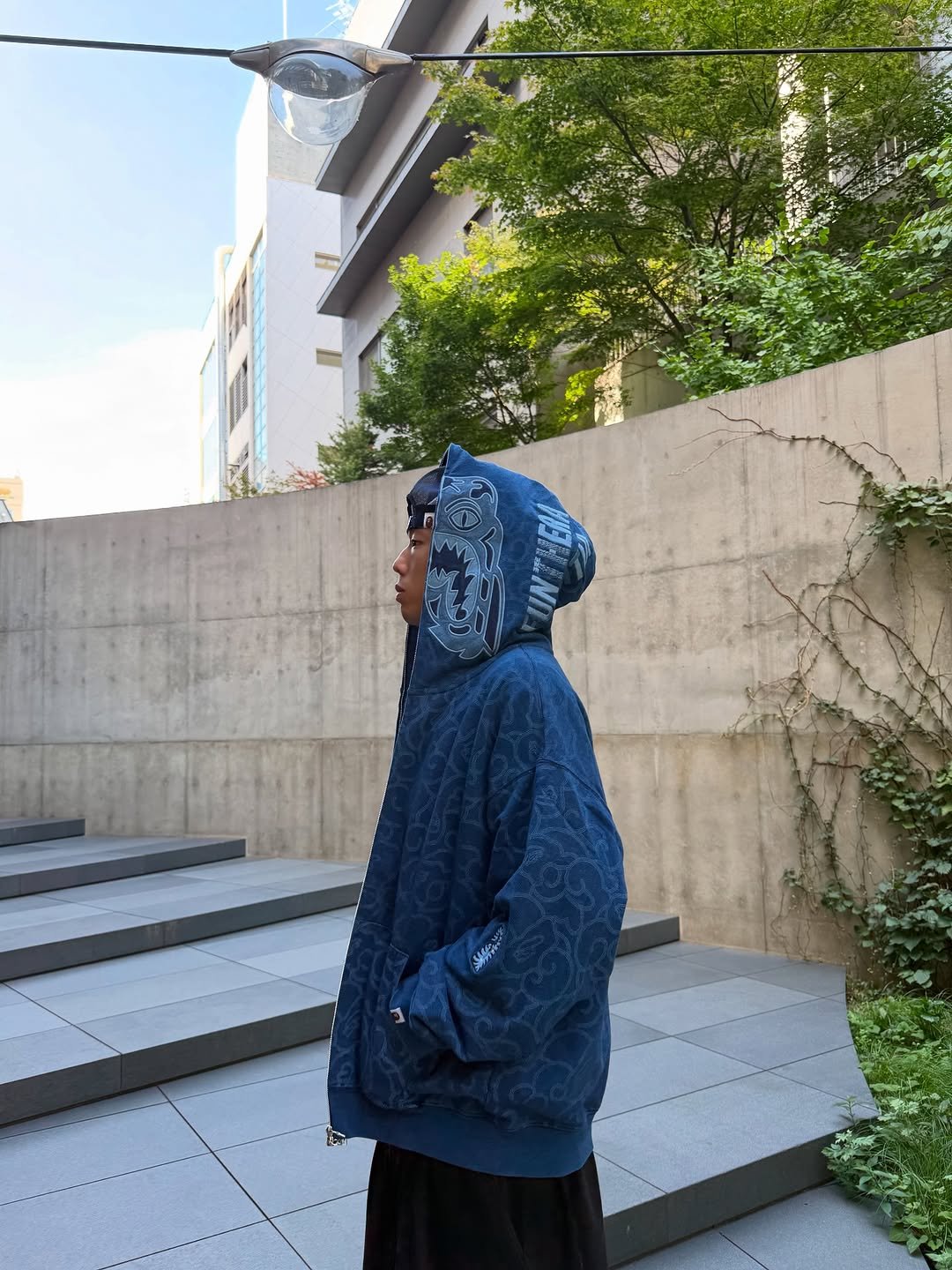 Photo shared by BAPE SEOUL on December 02, 2025 tagging @bapestorekorea, and @bape_seoul. May be an image of duffle coat, parka, cloak, raincoat, face mask and text.