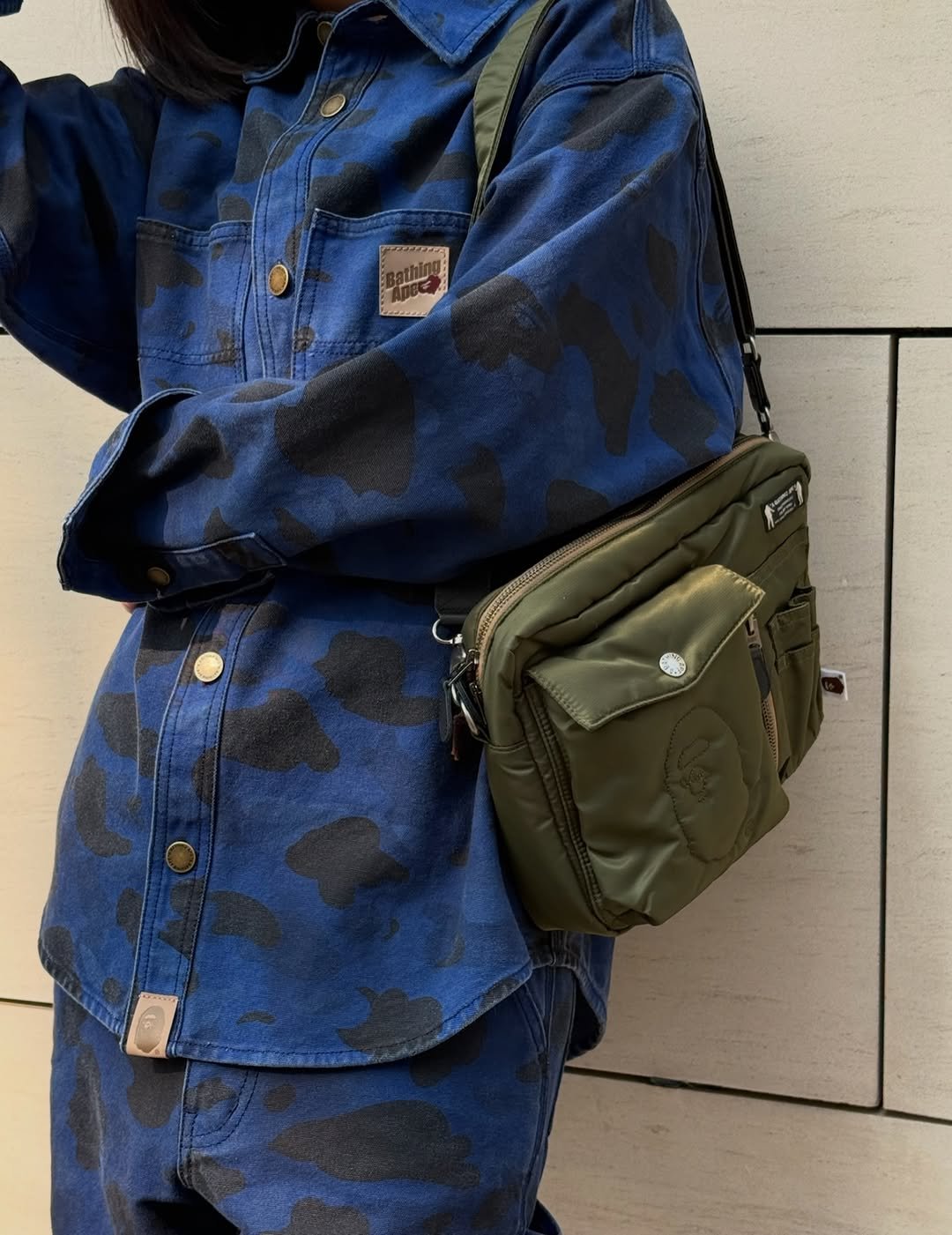 Photo shared by BAPE SEOUL on March 28, 2026 tagging @bapestorekorea, and @bape_seoul. May be an image of tool bag, drawstring, purse, parka, military uniform and text.