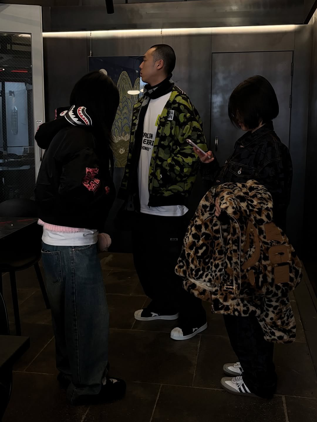 Photo shared by BAPE SEOUL on January 19, 2026 tagging @bapestorekorea, and @bape_seoul. May be an image of one or more people, people standing, duffle coat, flight jacket, parka and text.