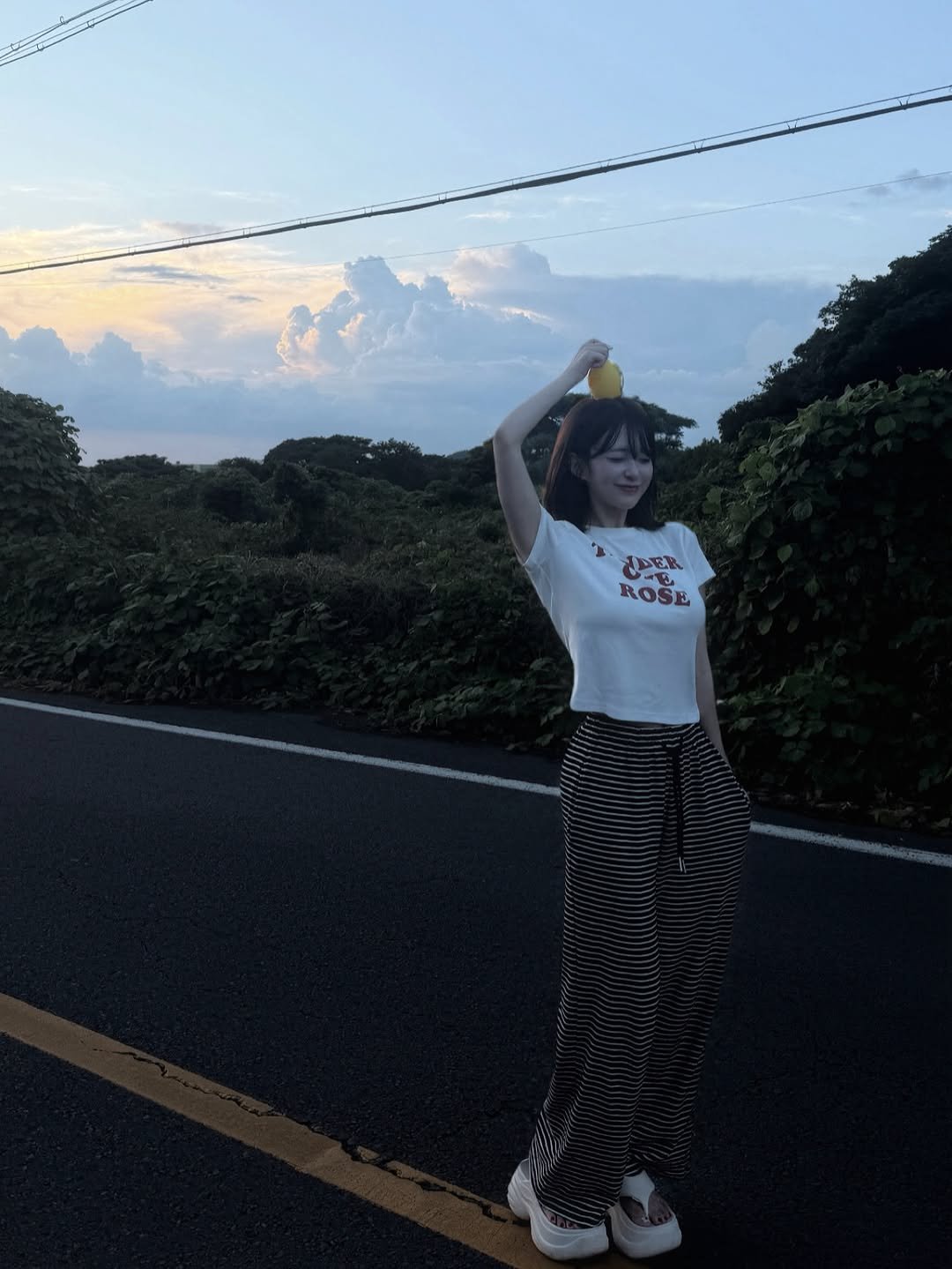 Photo by 빵귤(민지) on September 06, 2025. May be an image of 1 person, top, pie, cloud, twilight, road, telephone pole and text.