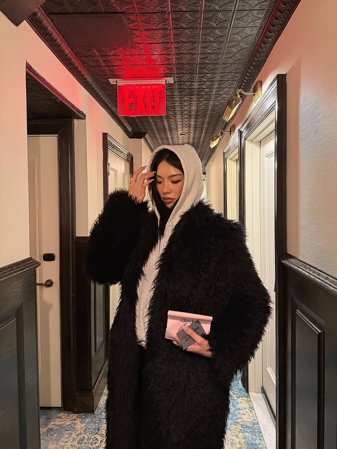 Photo by Amberly Yang on February 20, 2026. May be an image of sable coat, overcoat, goosedown coat, bath robe, robe, parka and text.