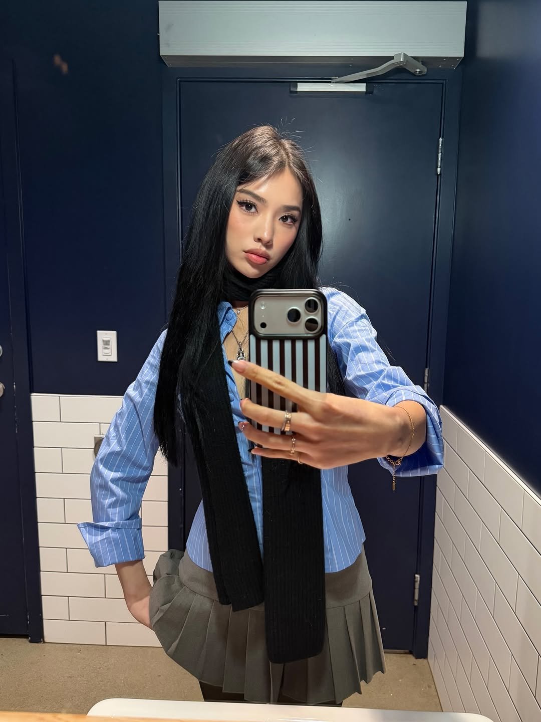 Photo by Amberly Yang on March 09, 2026. May be a selfie of one or more people, makeup, phone, miniskirt, mirror and text.