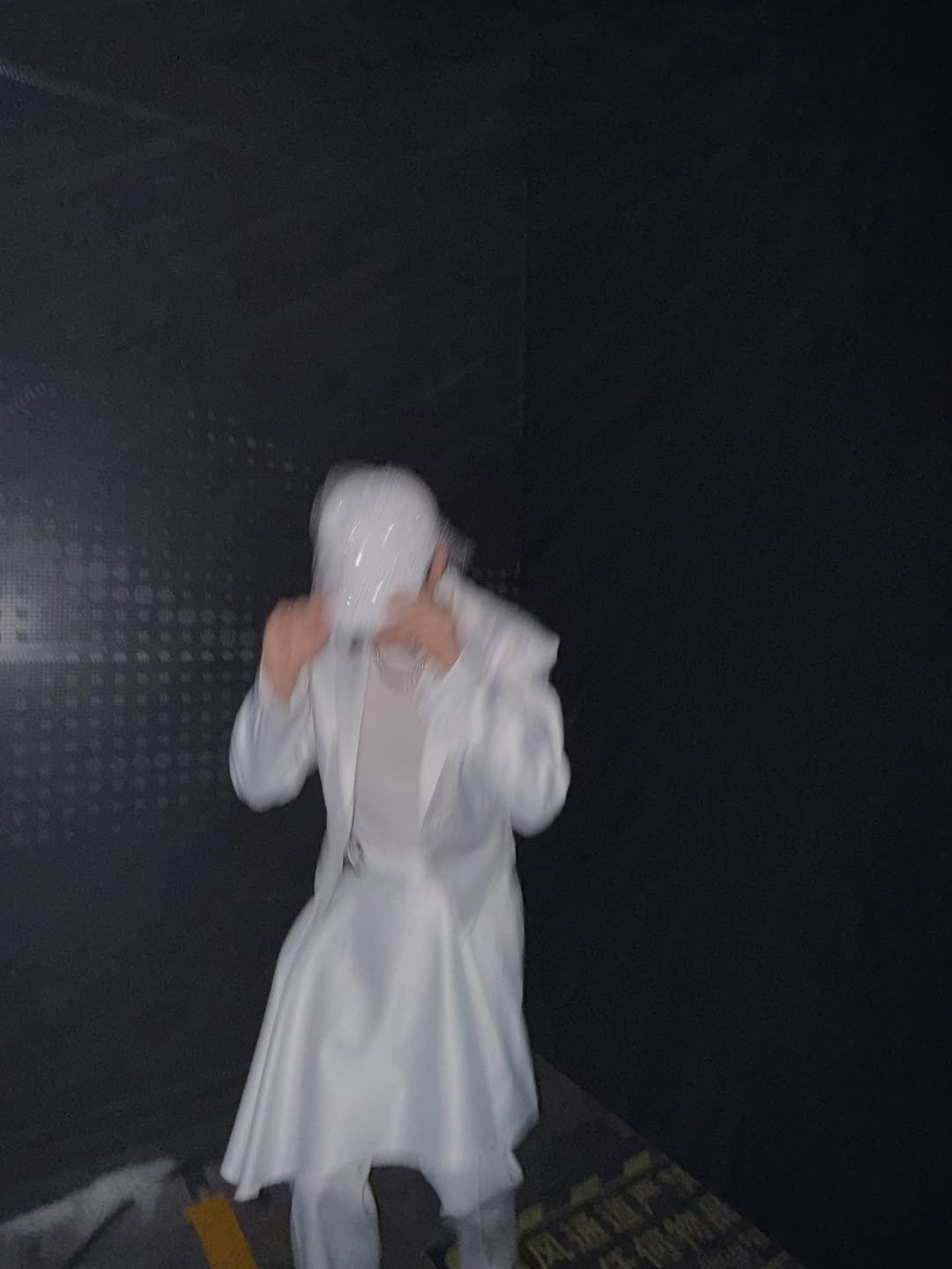 Photo by EUNHYUK on January 11, 2026. May be an image of overcoat, cloak, costume, bath robe, robe, parka, raincoat, face mask and text.