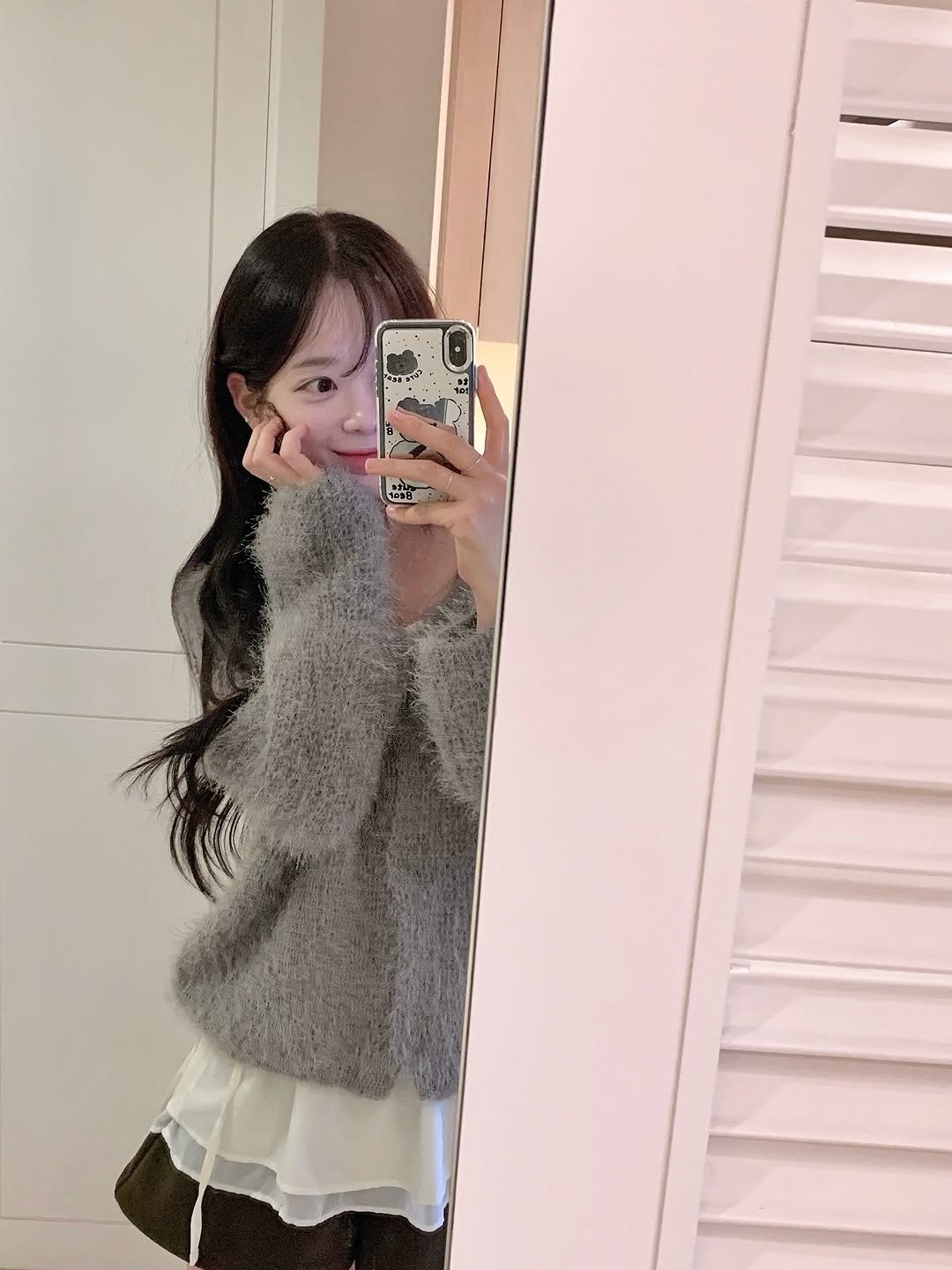 Photo by Lee Seulbi on November 10, 2025. May be an image of one or more people, hair, skirt, cardigan, miniskirt, mirror and text.