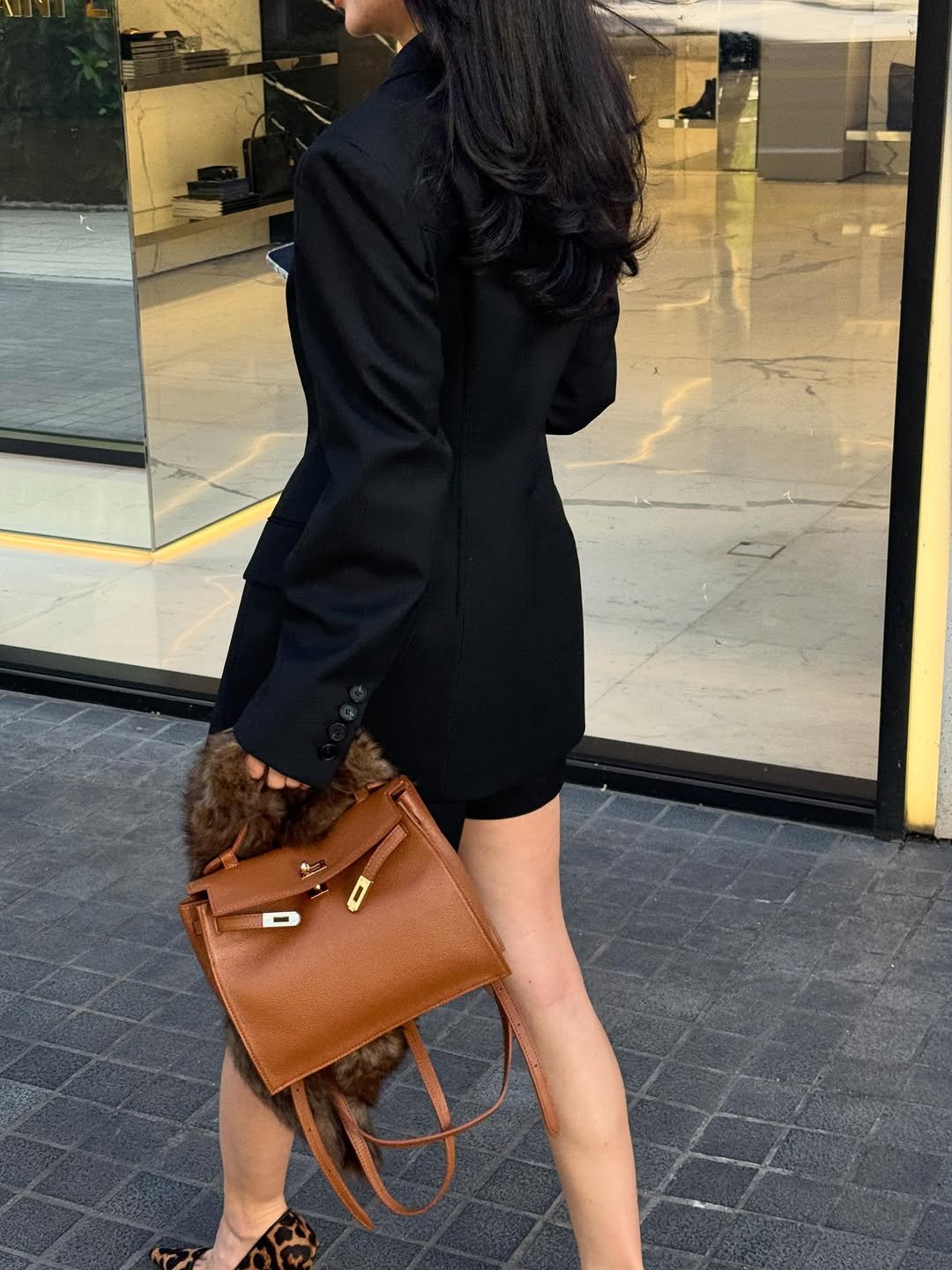 Photo shared by BELLELEAH on September 29, 2025 tagging @iamaflower. May be an image of 1 person, leather, blazer, suit, purse, slingback shoes and text.