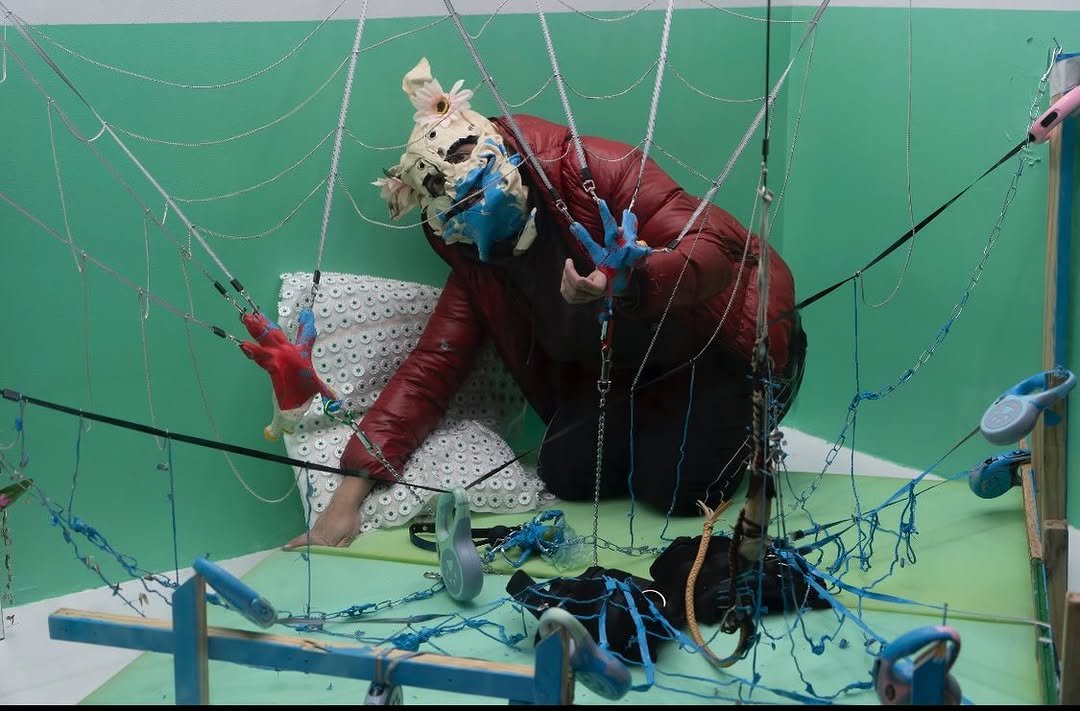 Photo shared by Below Grand Gallery on February 13, 2026 tagging @hwinx, and @aigerimakh. May be an image of vulture, spider, costume and text.