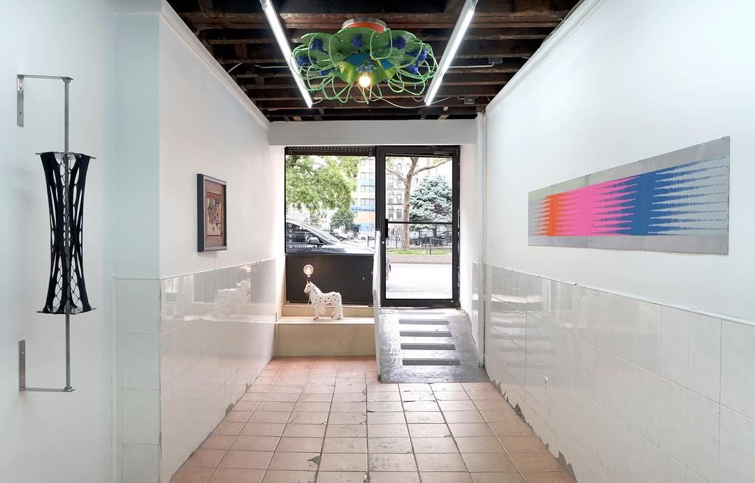 Photo by Below Grand Gallery on August 23, 2025. May be art of 1 person, indoors, hallway and text.