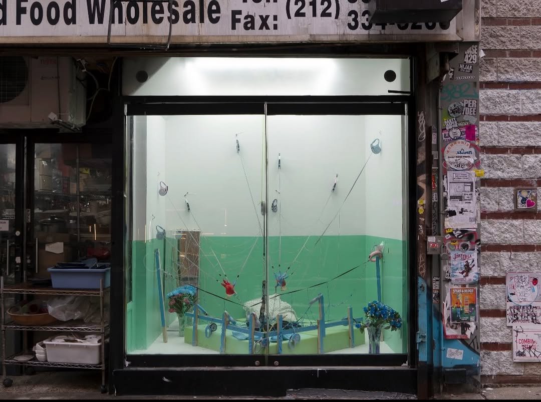 Photo shared by Below Grand Gallery on January 24, 2026 tagging @hwinx, and @aigerimakh. May be an image of display case, cash machine, signboard, vending machine, newsstand and text.