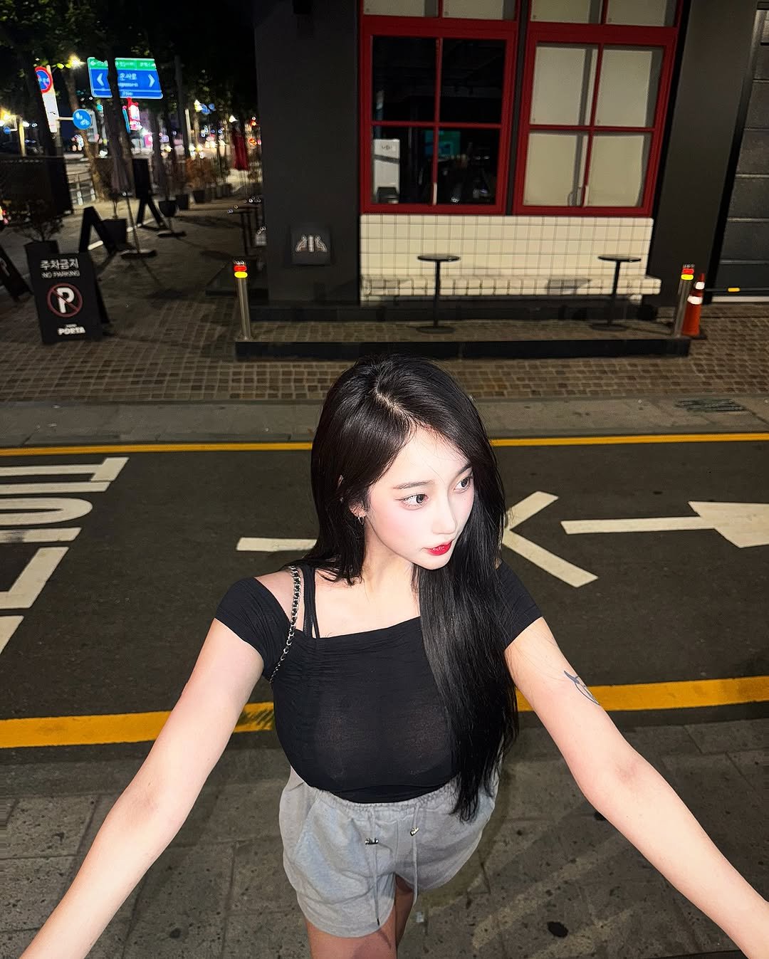 Photo shared by BIBI on July 30, 2025 tagging @minmi_official. May be an image of 2 people, hair, miniskirt, shorts, road, street and text.