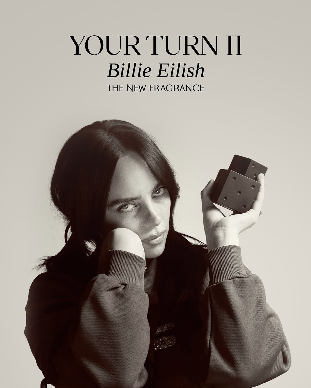 Photo shared by BILLIE EILISH on November 19, 2025 tagging @_glen_luchford, and @billieeilishfragrances. May be an image of one or more people, makeup, fragrance, perfume, magazine, poster, flask, portable cassette player and text that says 'YOUR TURN II Billie Eilish THΕ NEW FRAGRANCE'.