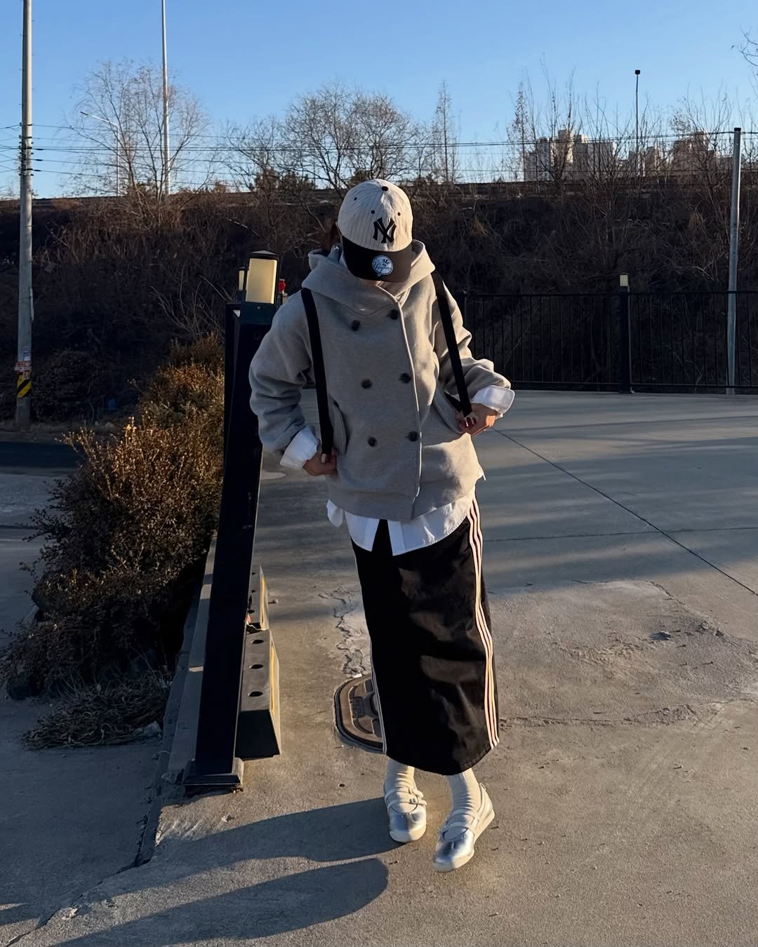 Photo by 현뱌 on February 18, 2026. May be an image of overcoat, wingtip shoes, duffle coat, gas mask, parka, face mask, street and text.
