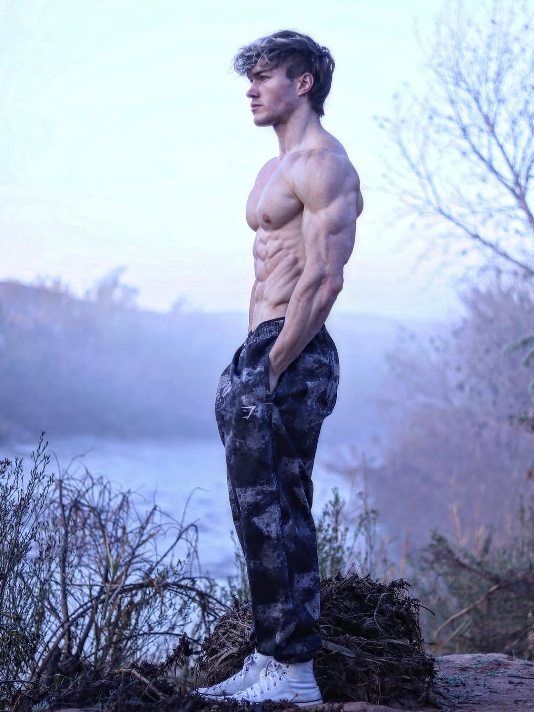 Photo shared by Jason Bjarnson on November 25, 2025 tagging @gymshark. May be an image of one or more people, biceps, people bodybuilding, people standing, sportswear, sweatpants, outdoors and text.