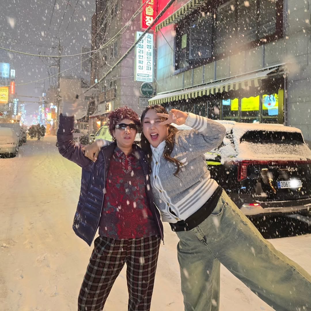 Photo shared by 풍자 on December 13, 2025 tagging @__ralral__. May be an image of one or more people, duffle coat, parka, snow and text.