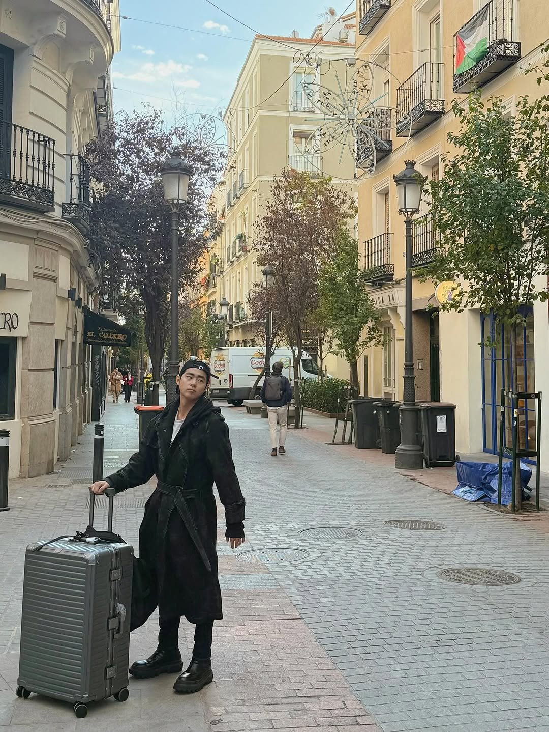 Photo by 조병규 on November 21, 2025. May be an image of suitcase, overcoat, briefcase, luggage, street and text.