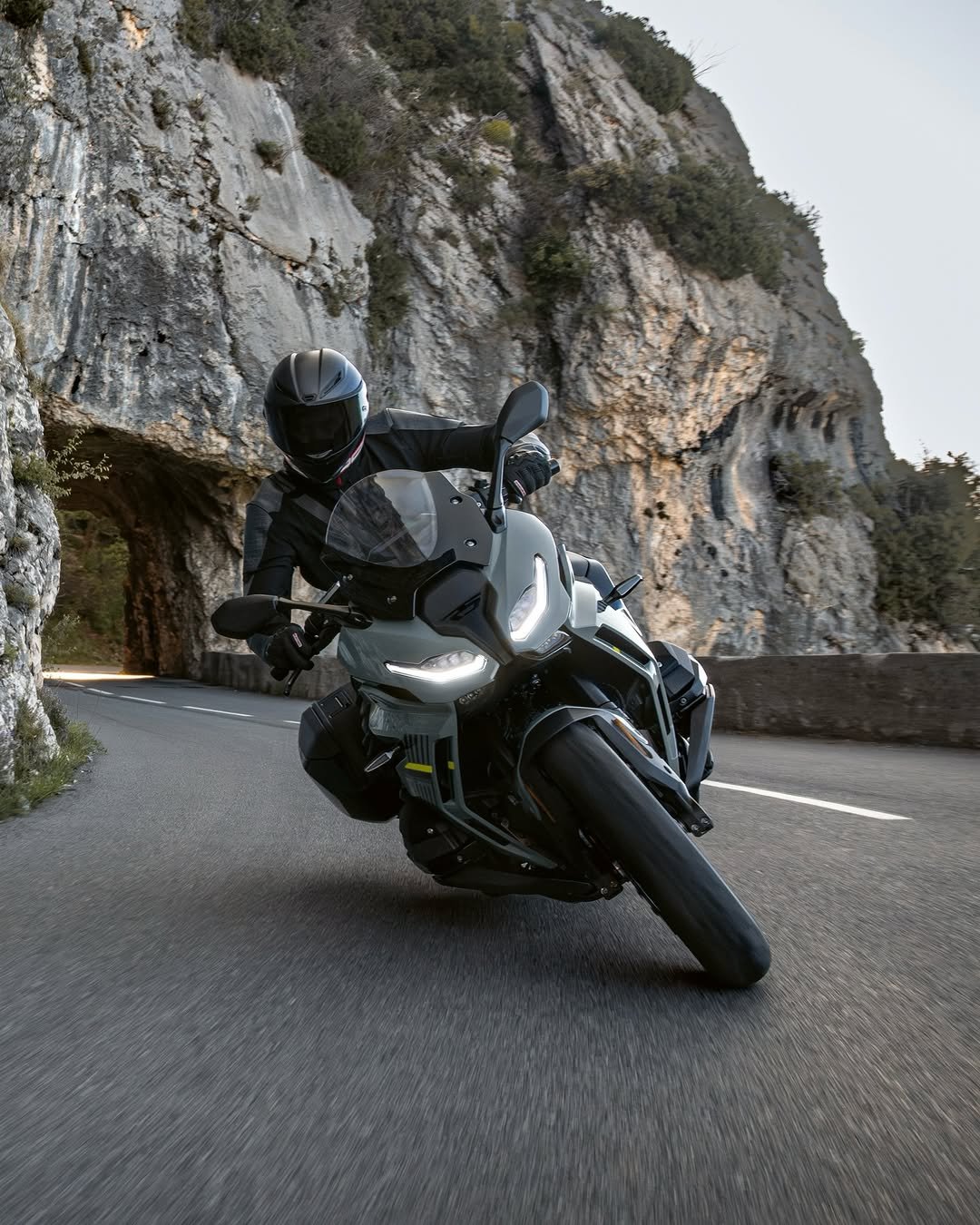 Photo by BMW Motorrad on December 21, 2025. May be an image of motorcycle, helmet, wheel, road and text.