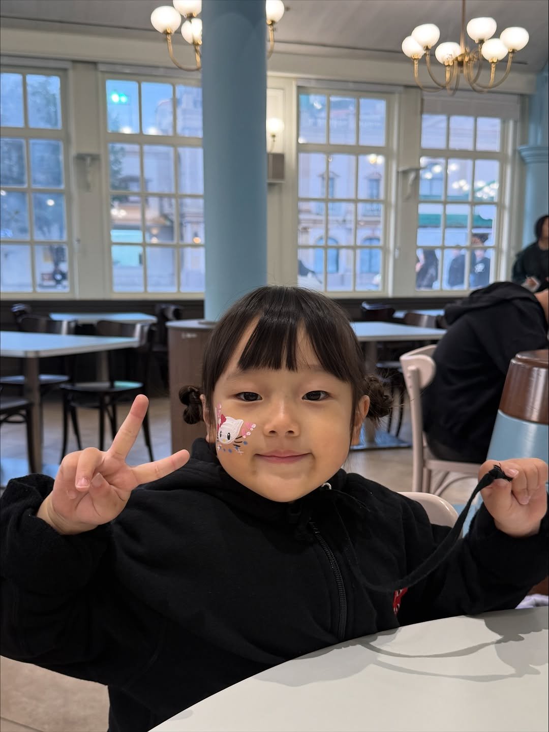 Photo shared by 석아영 on October 20, 2025 tagging @witheverland. May be an image of child, duffle coat, cornflower and text.