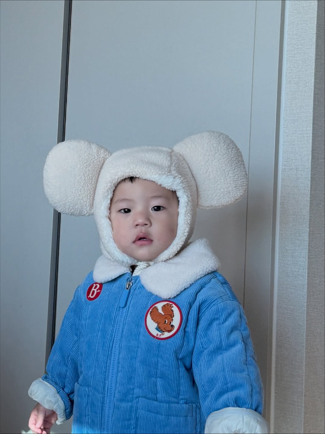 Photo by 석아영 on November 01, 2025. May be an image of baby, bear, duffle coat, hat, snowsuit and text.
