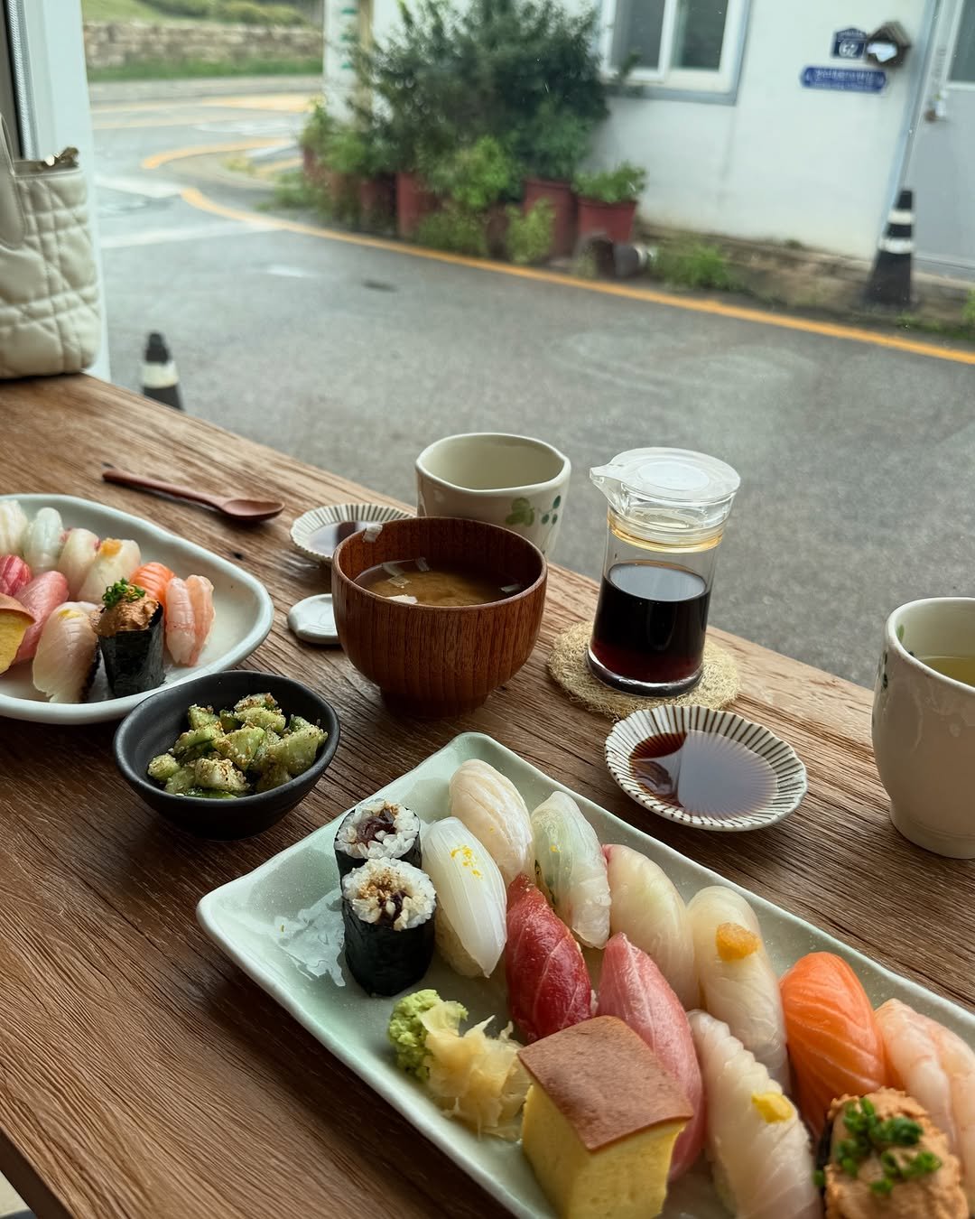 Photo by 석아영 on July 19, 2025. May be an image of sashimi, sushi, chopsticks, soy sauce and text.