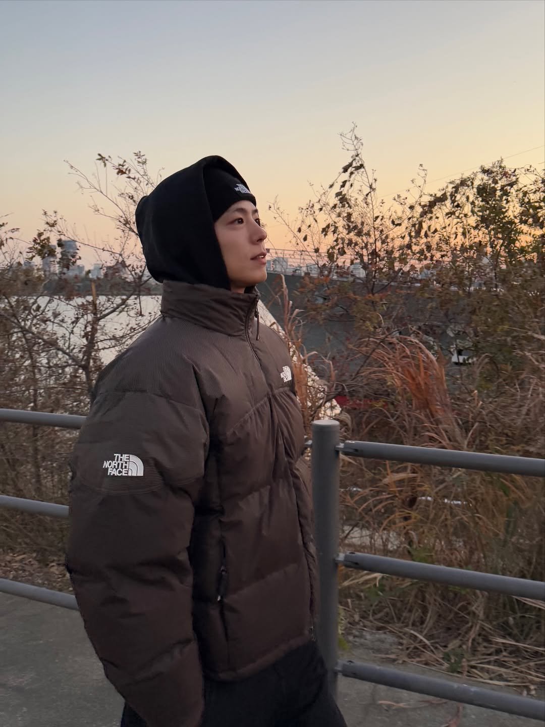 Photo shared by 박보검 PARK BO GUM on December 02, 2025 tagging @thenorthface_kr. May be an image of goosedown coat, duffle coat, parka, park and text.