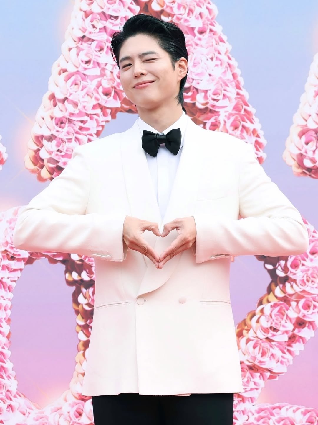Photo shared by 박보검 PARK BO GUM on December 07, 2025 tagging @aaa2025_10th. May be an image of one or more people, dinner jacket, bolo tie, top and text.