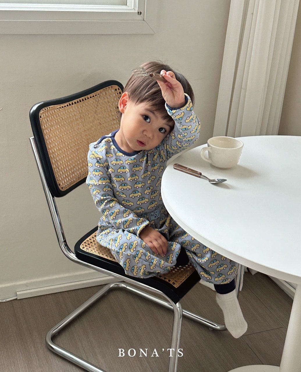 Photo by 보나츠 on September 24, 2025. May be an image of 1 person, baby, sleepwear, placemat, chair, tea and text that says 'o 0o Coa BONA'TS TS'.