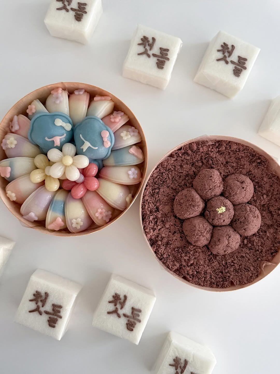 Photo by 봉앗간 | 떡케이크 | 백일떡 | 답례떡 | 클래스 on March 16, 2026. May be an image of chocolate bar, sink, bar soap, wafer, globe amaranth and text that says '첫돌 첫돌 量'.