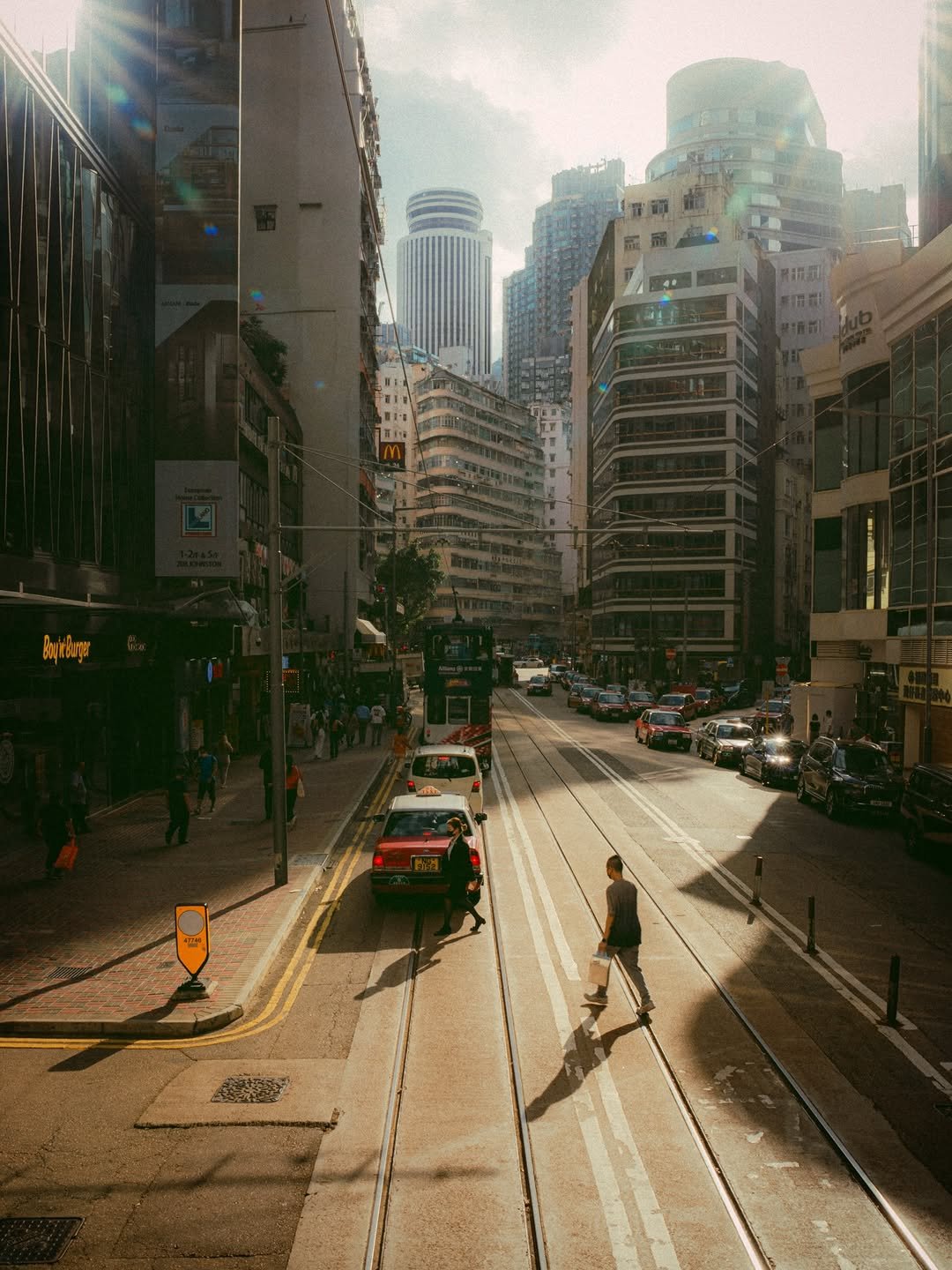 Photo shared by 봉토그래퍼 📷 on March 11, 2026 tagging @discoverhongkong, @sonykorea, @sonyalpha, @voyaged, and @hongkong.explore. May be an image of one or more people, cablecar, skyscraper, street, road, buildings and text.
