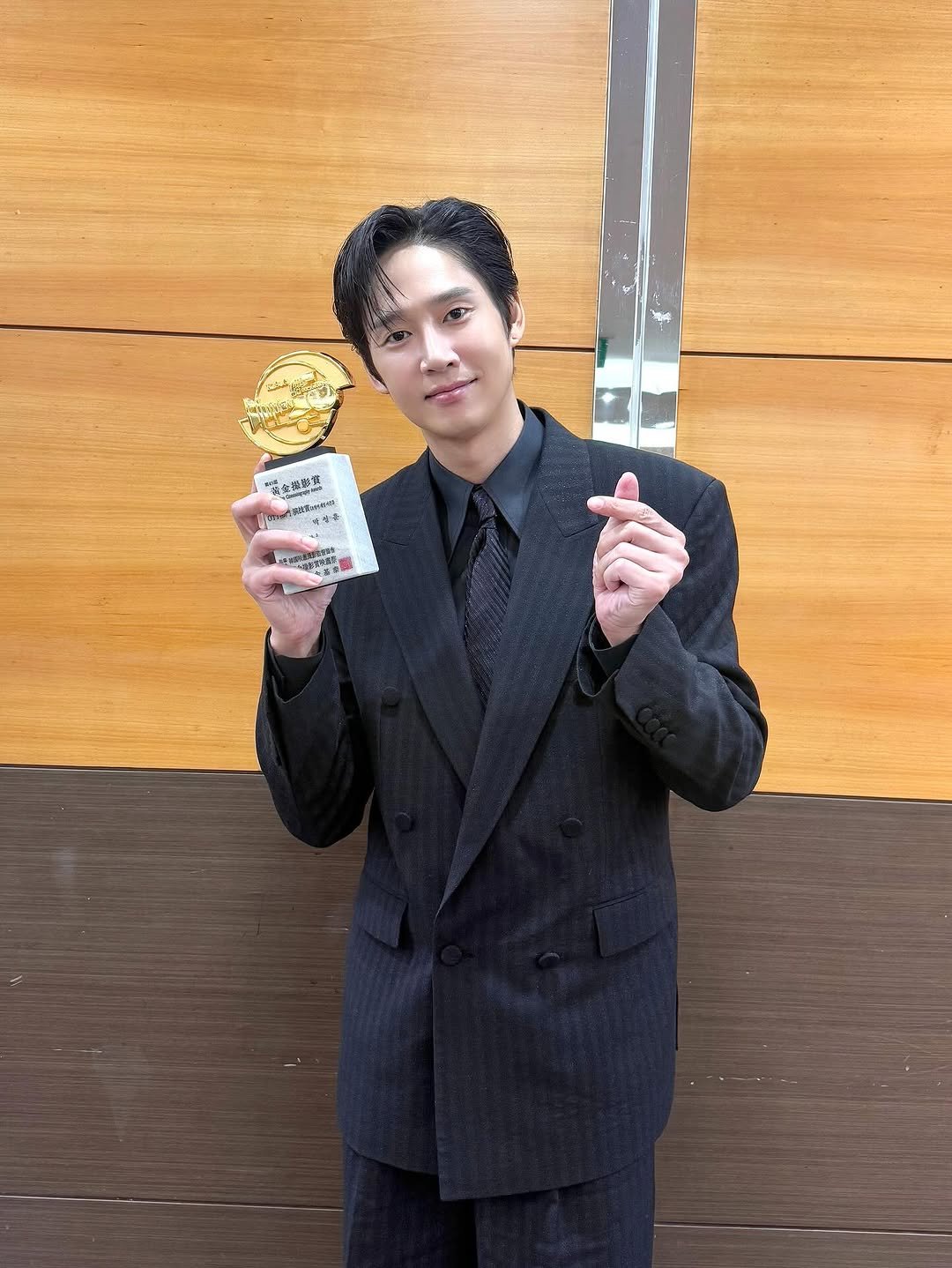 Photo by 박스아범 박성훈 on October 02, 2025. May be an image of 1 person, suit, bolo tie, blazer and text.