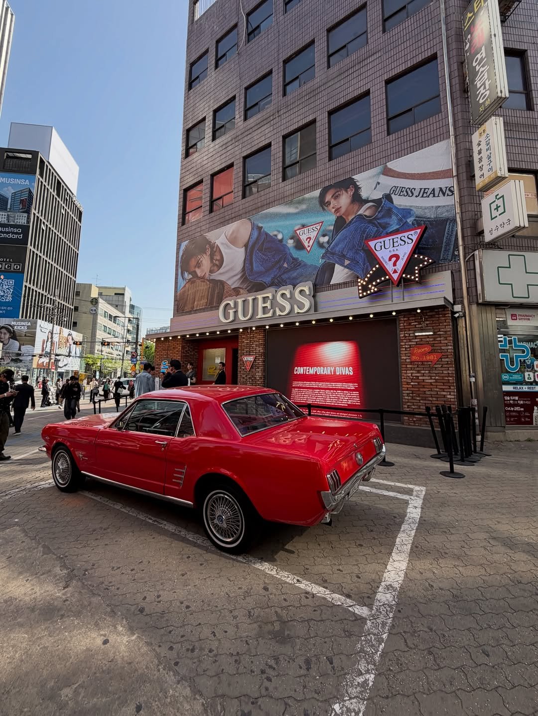 Photo shared by 브만남 (브랜드 만드는 남자) on April 23, 2026 tagging @guess, @guesskorea, and @hynjinnnn. May be an image of car, signboard, street and text.