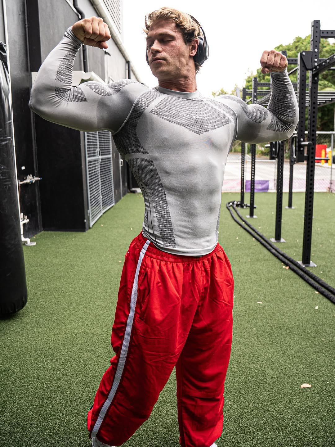 Photo by Brandon Starr on February 26, 2026. May be an image of one or more people, biceps, people bodybuilding, Superman, activewear, punching bag, sportswear and text.