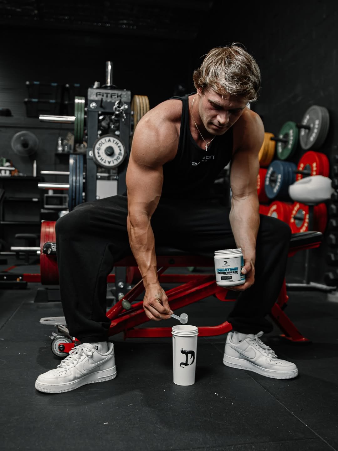 Photo shared by Dragon Pharma on January 07, 2026 tagging @brandonsstarr. May be an image of one or more people, biceps, people bodybuilding, shaker, sportswear, jug, bottle, dumbbell, water bottle and text.