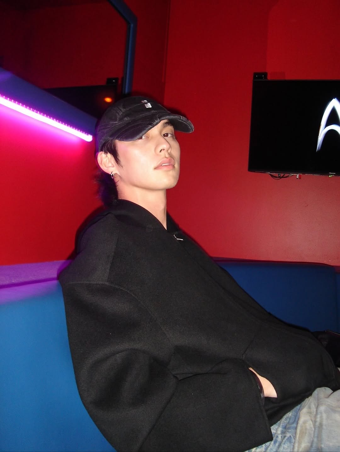 Photo by BRIGHT on November 05, 2025. May be an image of one or more people, people smoking, hookah, duffle coat, hat, cigarette, beret and text.