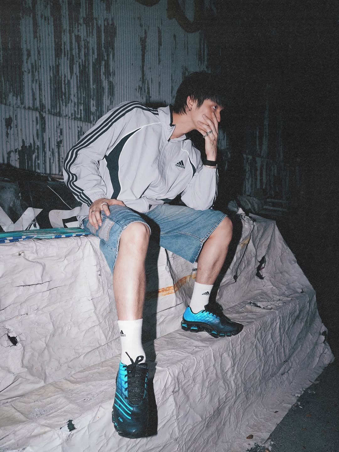 Photo shared by BRIGHT on April 11, 2026 tagging @adidasoriginals, and @adidasthailand. May be an image of cigarette, sweatpants, sportswear and text.