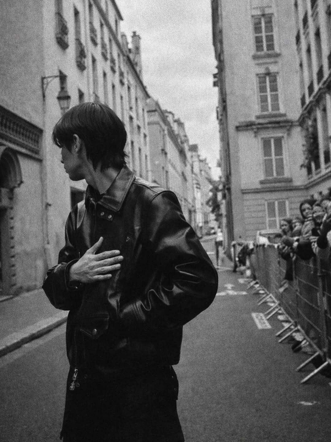 Photo by BRIGHT on December 26, 2025. May be a black-and-white image of one or more people, people smoking, overcoat, cigarette, beret, street and text.
