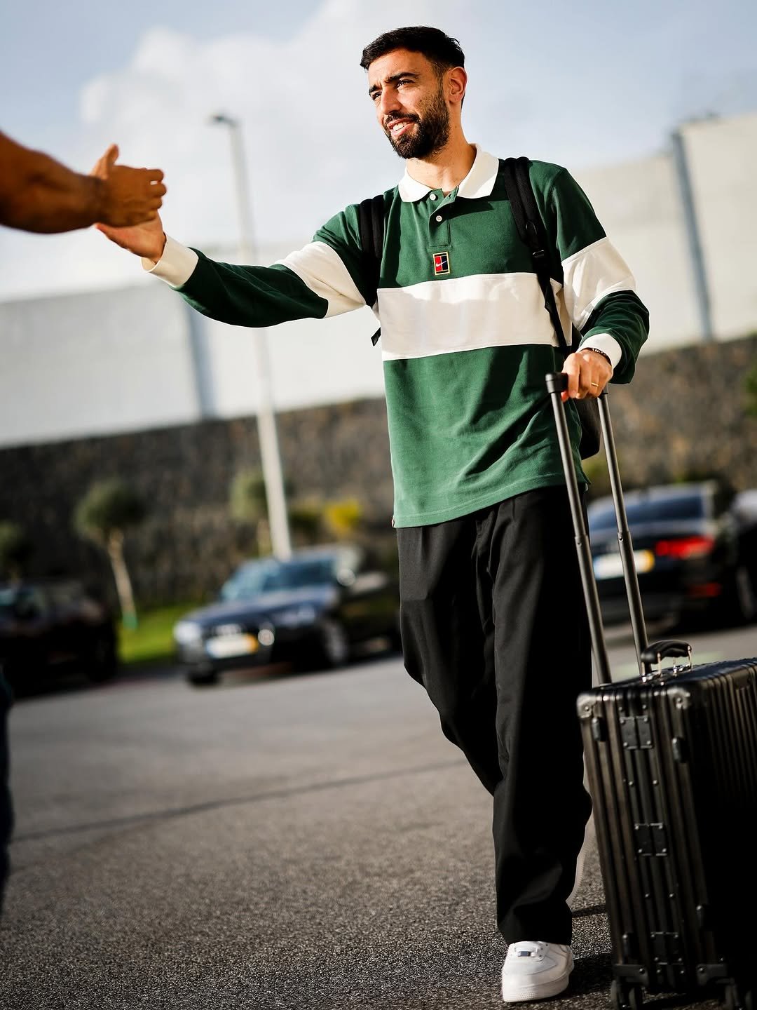 Photo by Bruno Fernandes on November 11, 2025. May be an image of one or more people, beard, people standing, suitcase, sportswear, luggage, sweatpants and text.