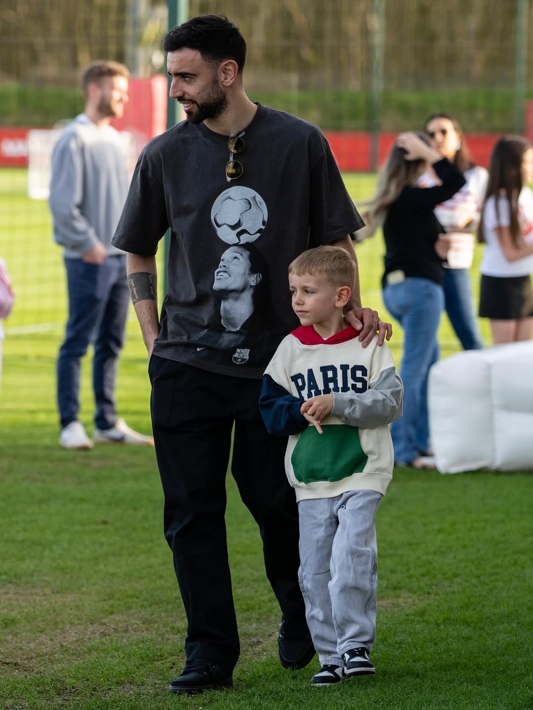 Photo shared by Bruno Fernandes on April 24, 2026 tagging @ronaldinho. May be an image of child, soccer, stadium and text that says 'PARIS'.