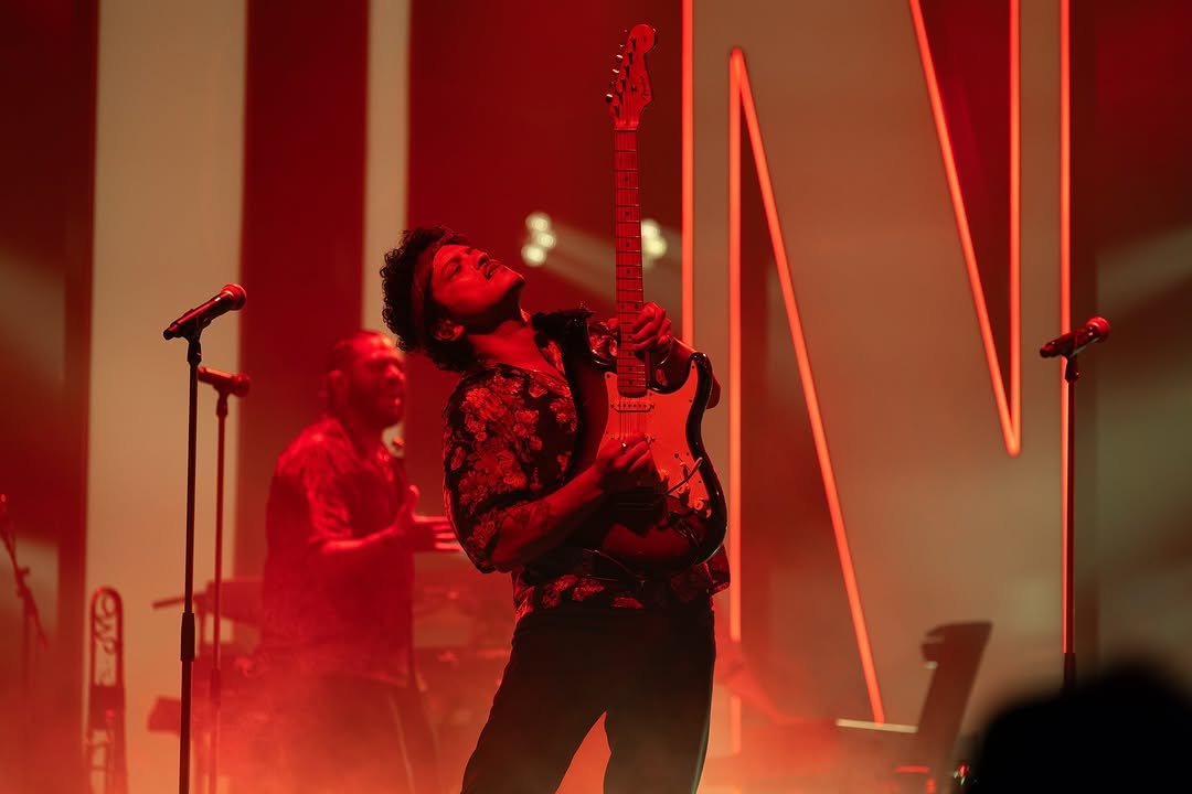 Photo by Bruno Mars on August 28, 2025. May be an image of 2 people, saxophone, guitar, concert and text.