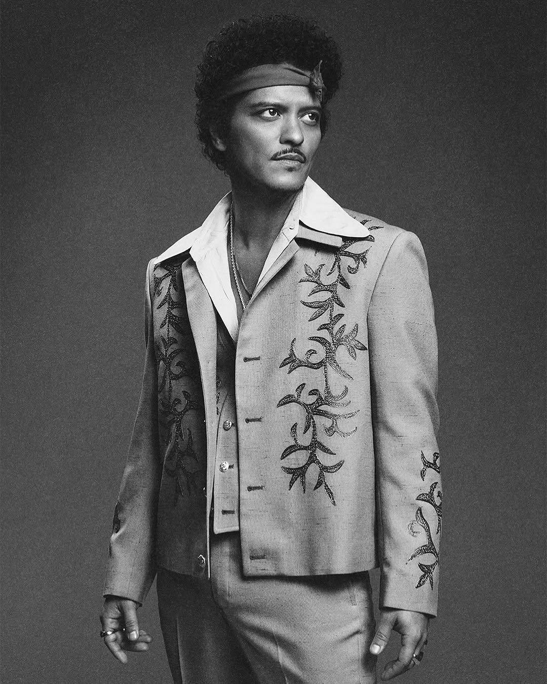 Photo by Bruno Mars on January 09, 2026. May be a black-and-white image of one or more people, suit, dinner jacket and text.