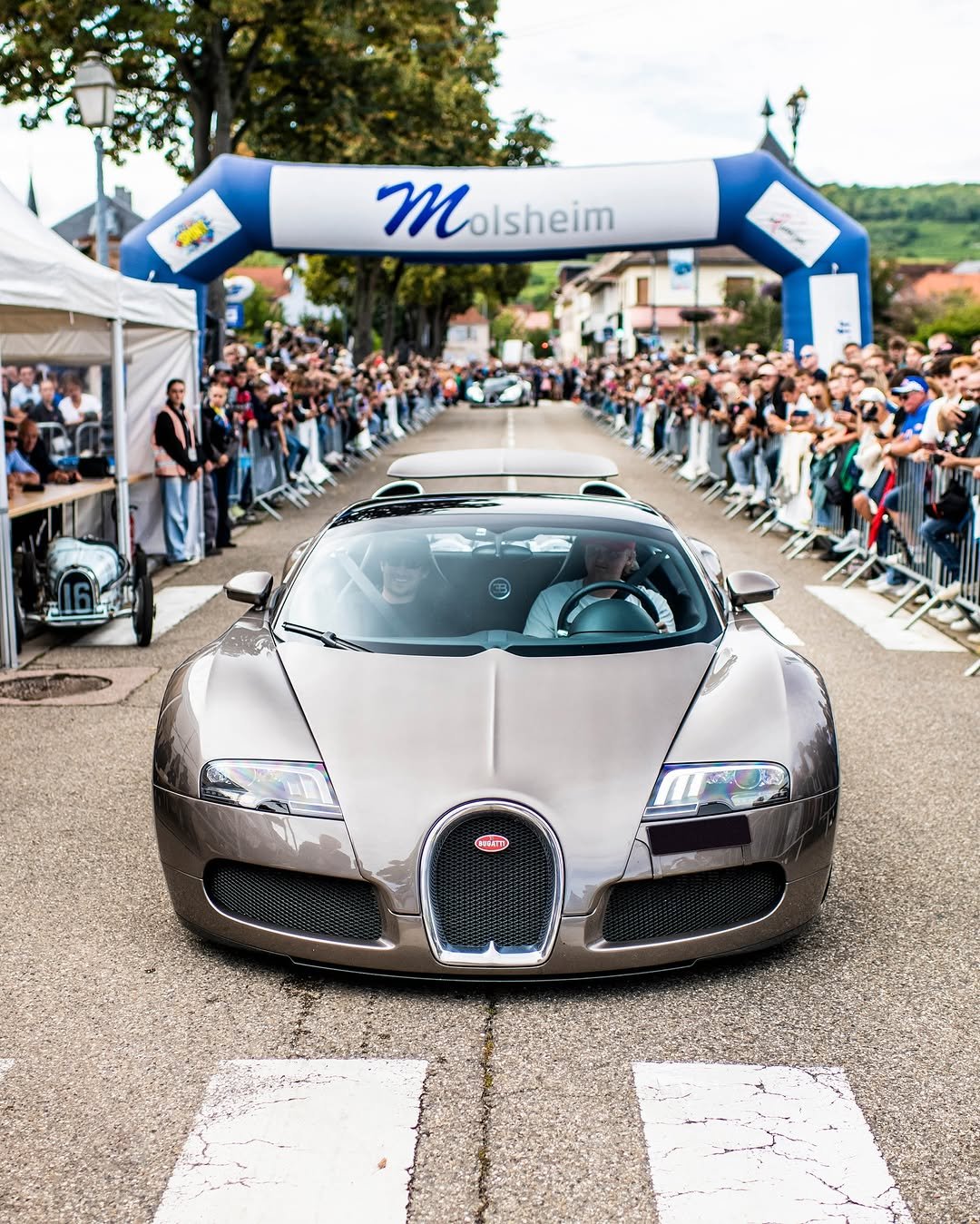 Photo by BUGATTI on September 18, 2025. May be an image of 3 people, people racing vehicles, race car, wheel, road and text that says 'Molsheim cam'.