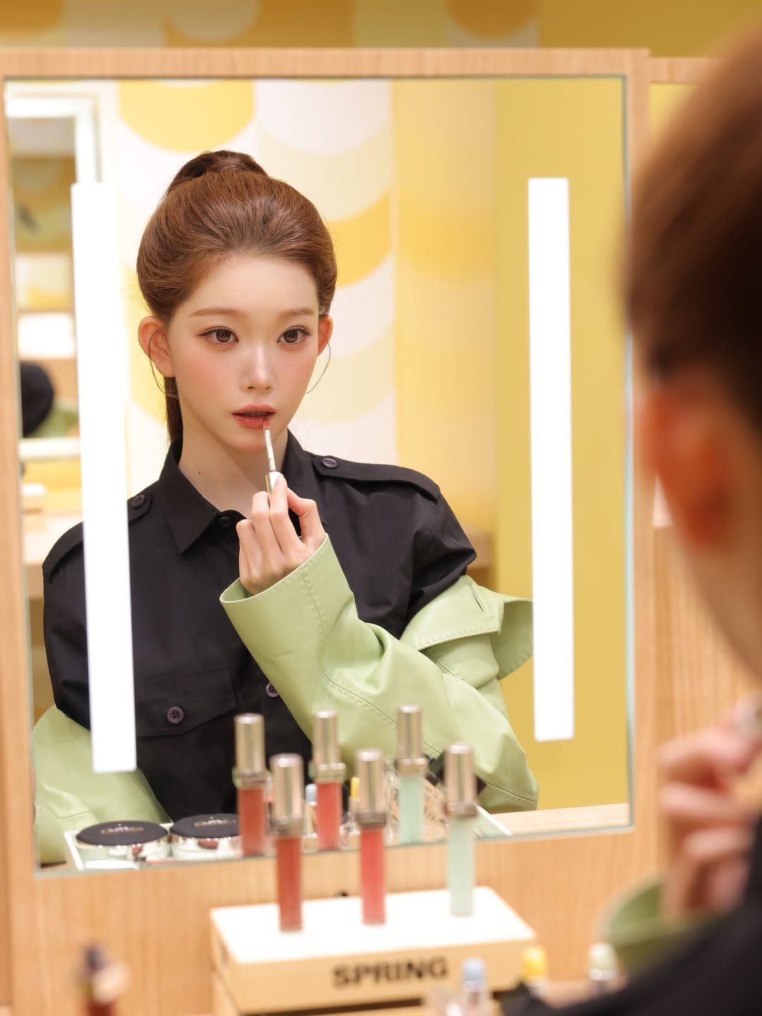 Photo shared by 츠키 TSUKI on March 27, 2026 tagging @prada, and @pradabeauty. May be an image of one or more people, makeup, lipstick, hair, mirror and text that says 'SPRING'.