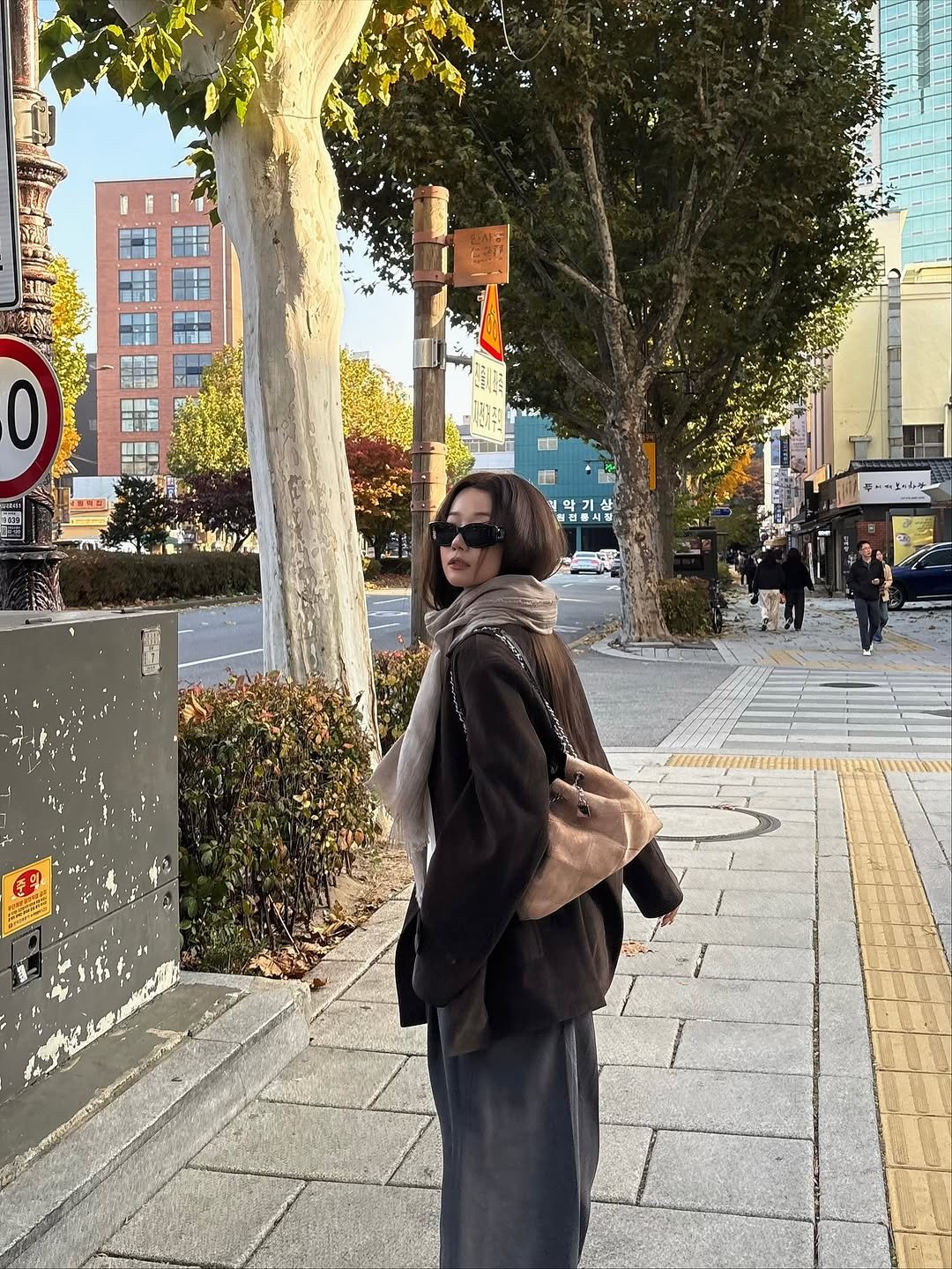Photo shared by 배지연 on November 16, 2025 tagging @cardinal__red. May be an image of one or more people, duffle coat, overcoat, cornflower, street and text.