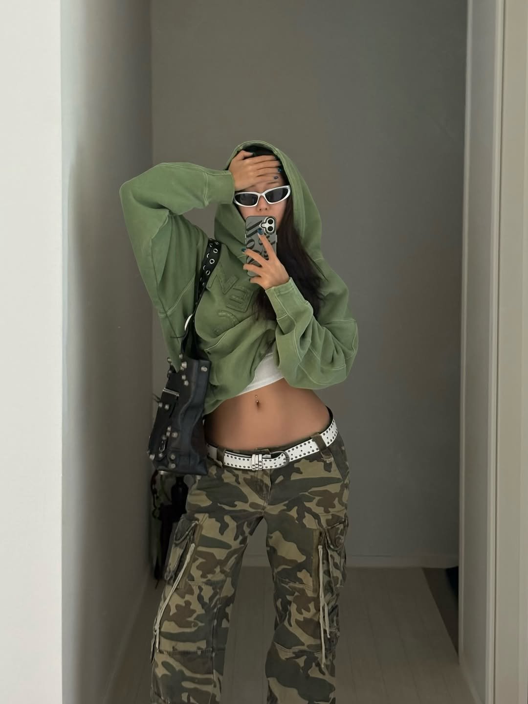 Photo shared by 배지연 on February 09, 2026 tagging @by_eccentric. May be an image of sweatpants, military uniform, face mask, parka and text.