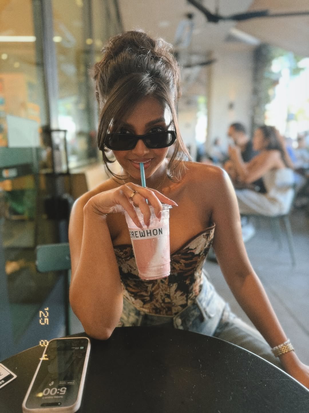 Photo by zareefa ahmed-arije on August 05, 2025. May be an image of 1 person, phone, drink, eyewear, cigarette and text.