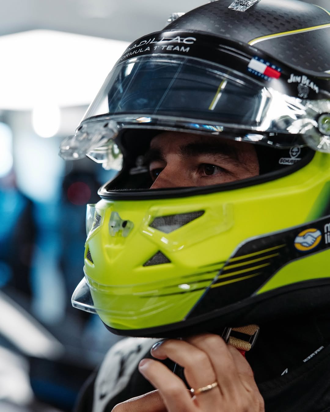 Photo shared by Cadillac Formula 1 Team on January 16, 2026 tagging @schecoperez, and @cadillac. May be an image of racing vehicles, race car, helmet and text.