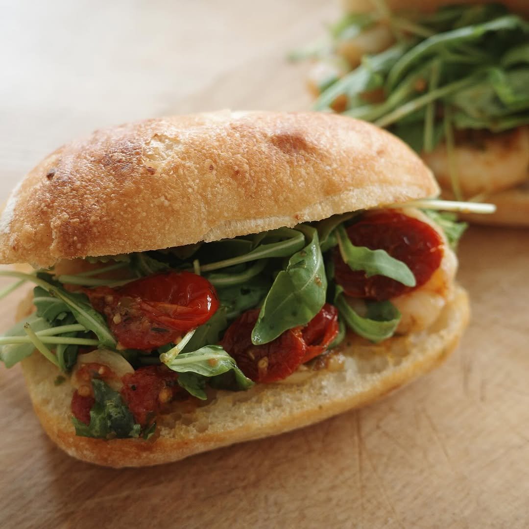 Photo by ekorre_cafe & grocery on August 14, 2025. May be an image of baguette, chicken sandwich, tomato and text.
