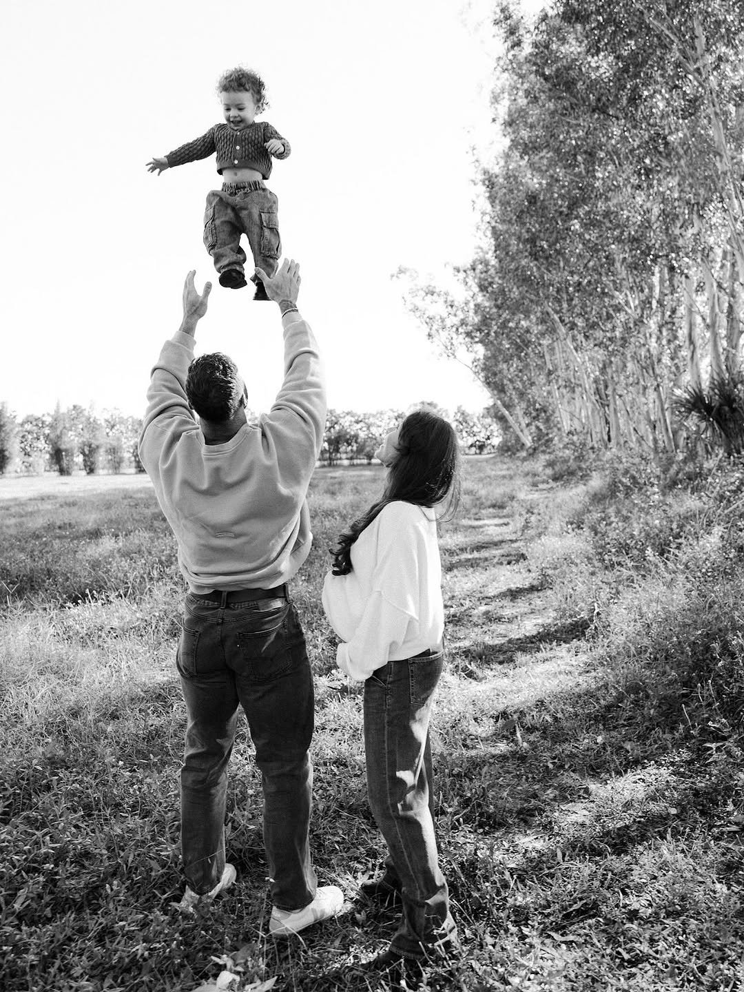 Photo shared by Chris Bumstead on November 14, 2025 tagging @courtneykiing, and @karlykreative. May be a black-and-white image of baby, standing, outdoors and text.